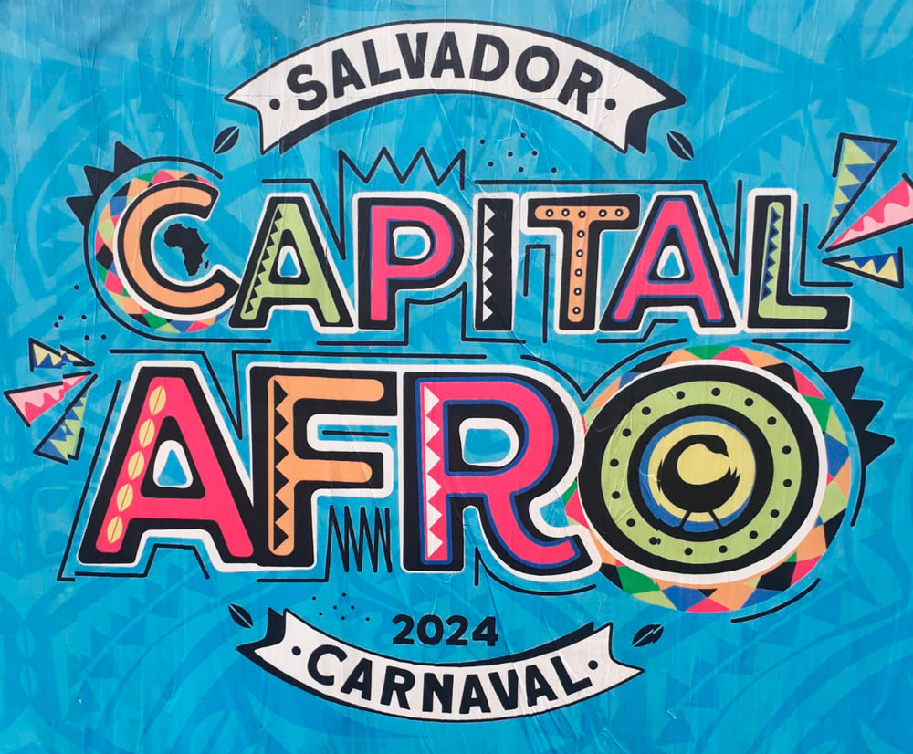 Cartaz com fundo azul e letras coloridas, com a escrita "Salvador Capital Afro - Carnaval 2024"